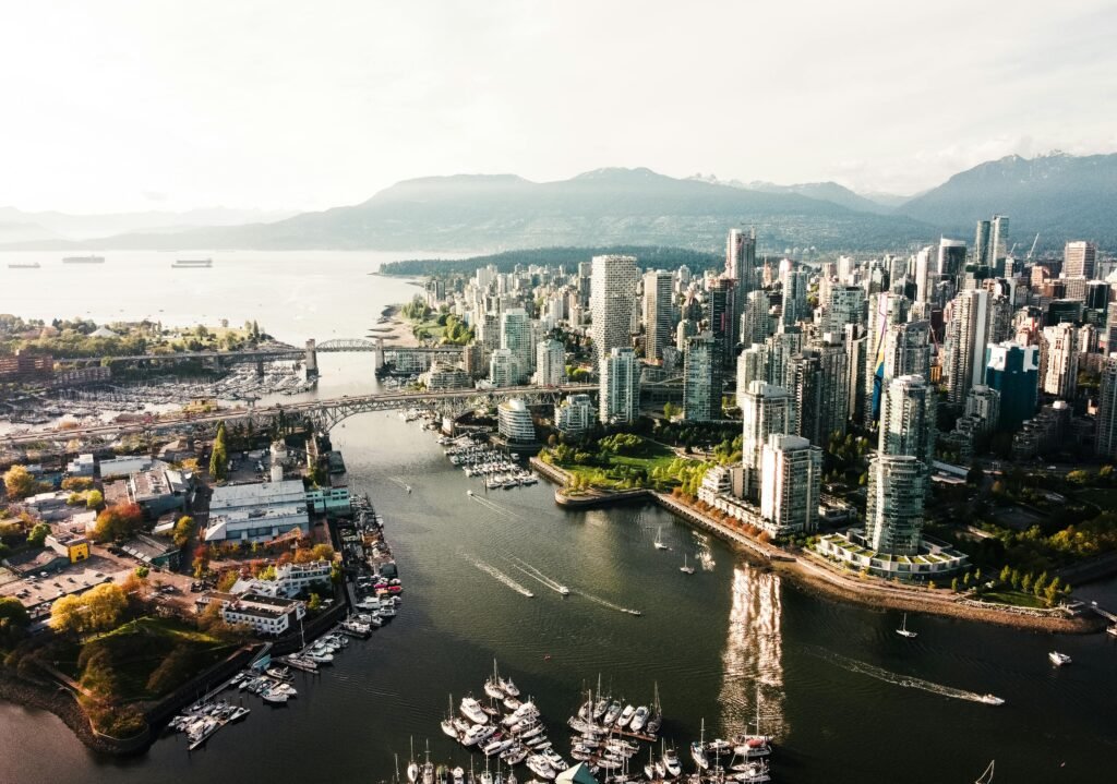 Dramatic aerial view of Vancouver's cityscape, capturing skyscrapers and waterways.