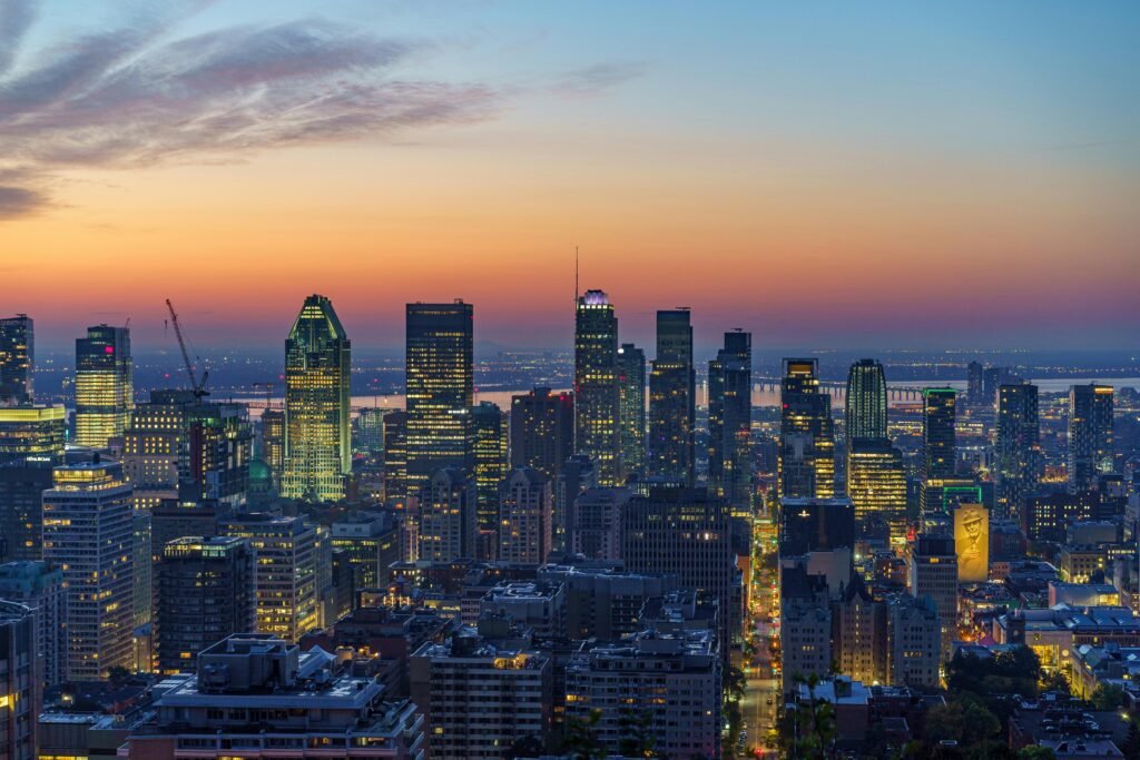 A captivating aerial view of Montreal's skyline illuminated at sunset, showcasing vibrant urban life.