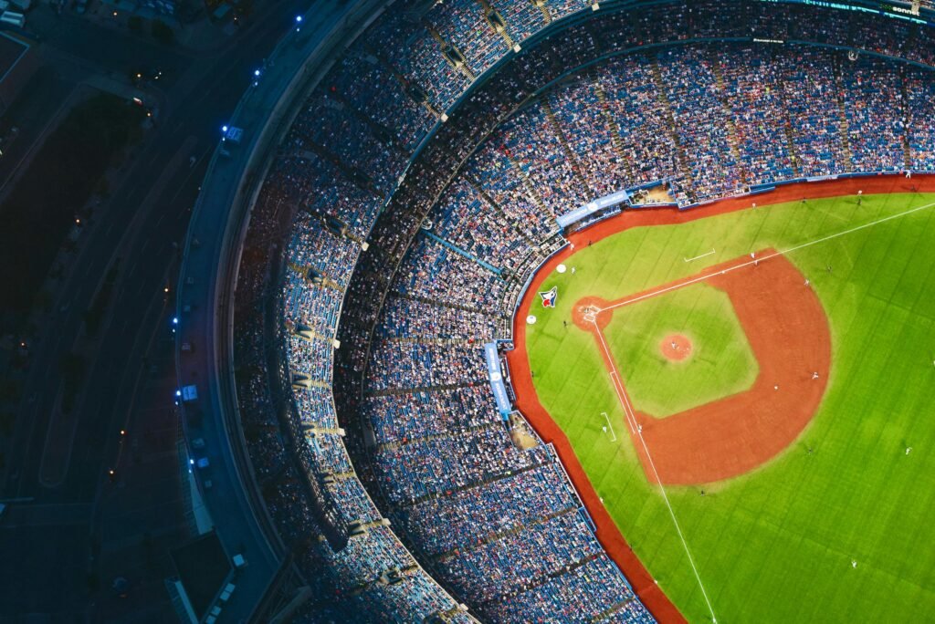 High-angle view of a crowded baseball stadium with green field in Toronto during a game.