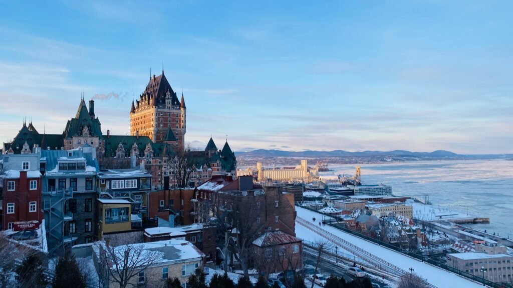 A winter vista of Québec City featuring the iconic Château Frontenac against a snowy skyline.